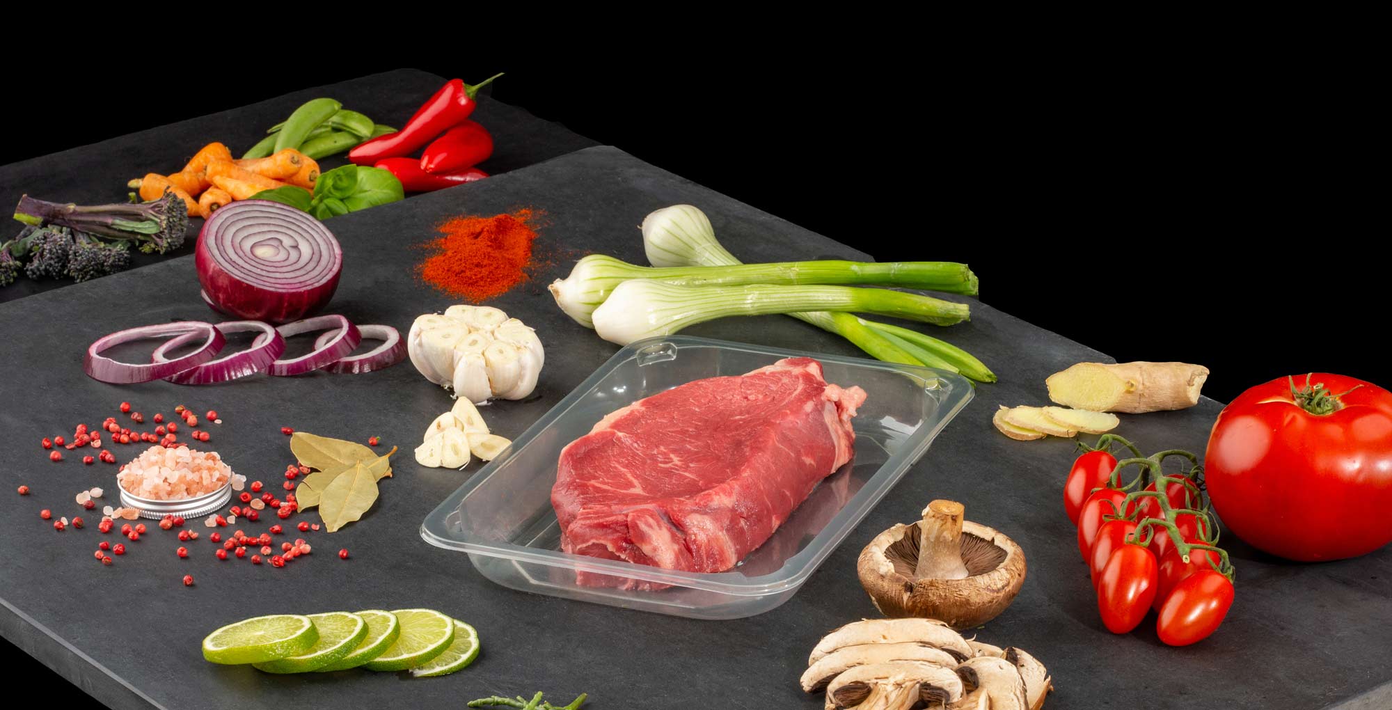 Professional brand photography of iPac iZorb container with premium meat showing high-quality food packaging solutions
