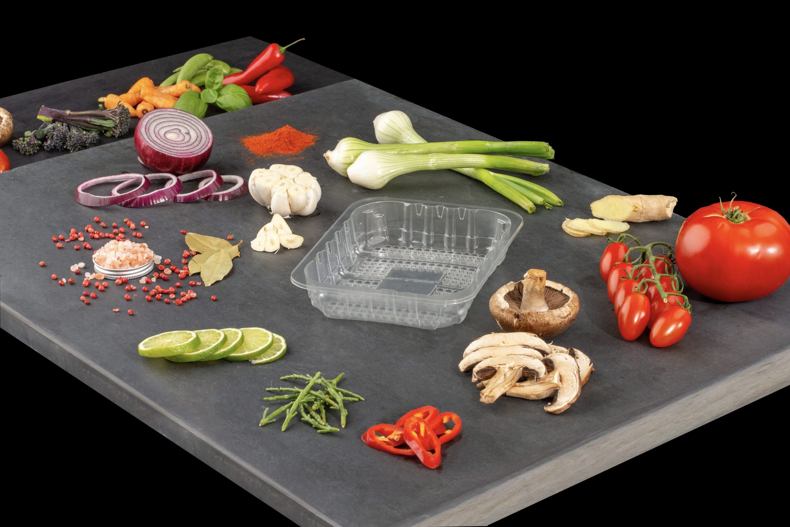 Professional brand photography showing iPac iZorb container with fresh vegetables demonstrating real-world food packaging applications