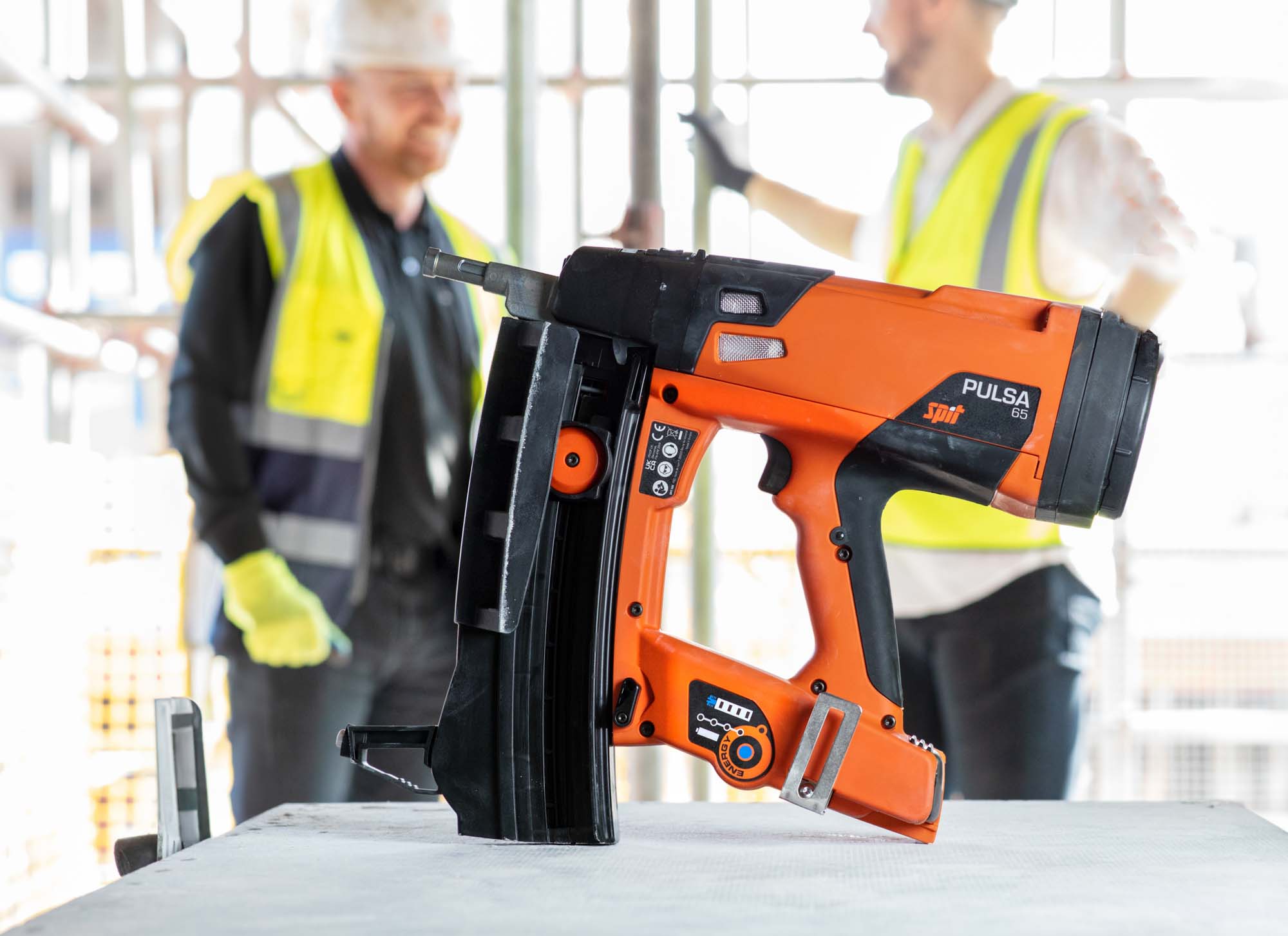 Professional product brand photography of SPIT nail gun with construction context