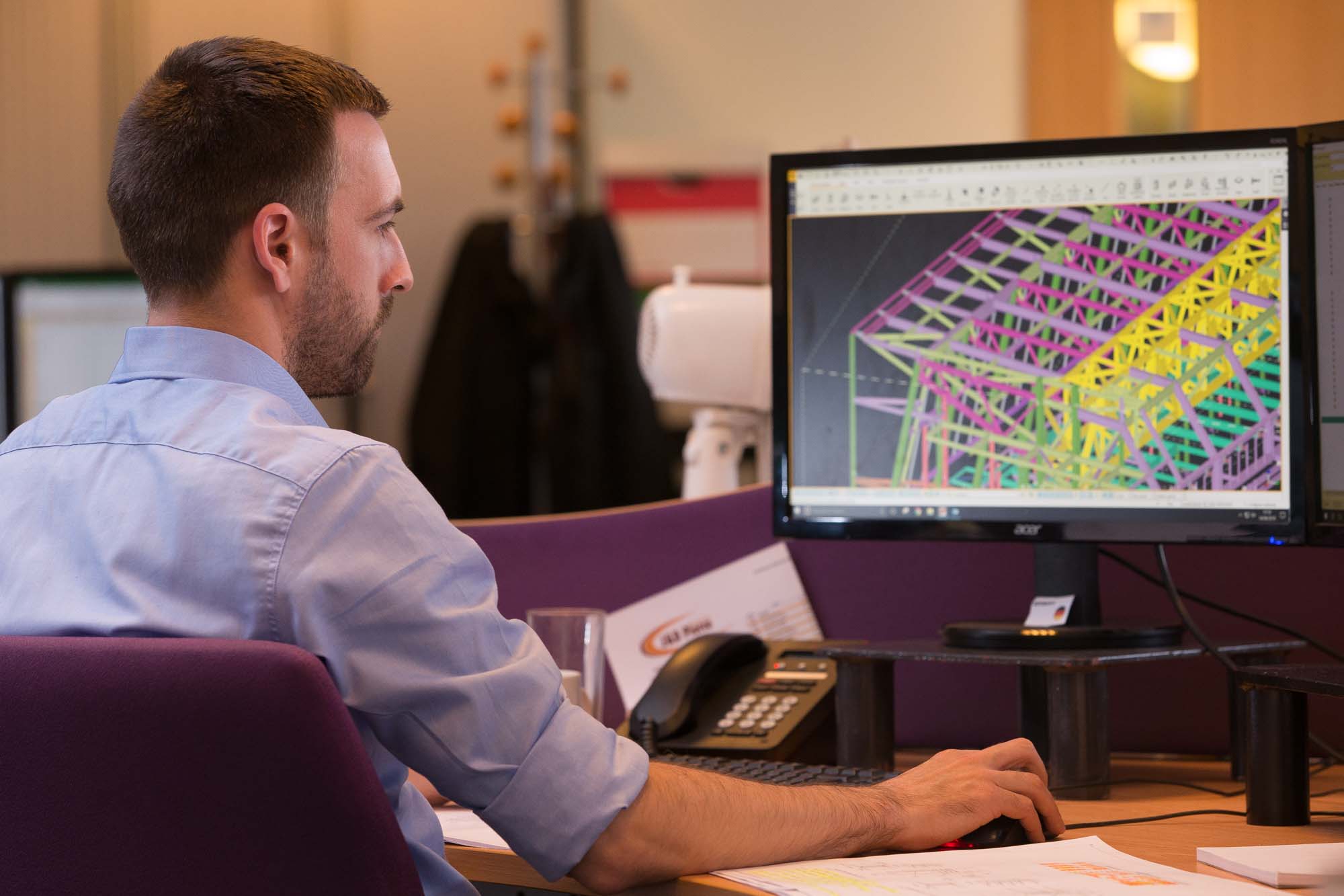 Professional brand photography of engineer working with CAD design software